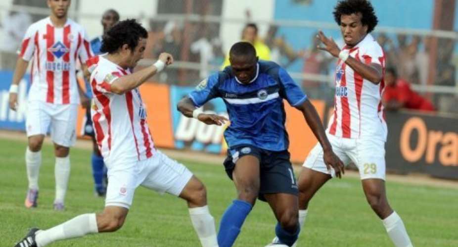 Wydads Allaoui Mustapha (left) and Ayoub El-Khaliqi (right) tackle Enyimbas Uche Kalu in the semi-finals last month.  By Pius Utomi Ekpei (AFP/File)