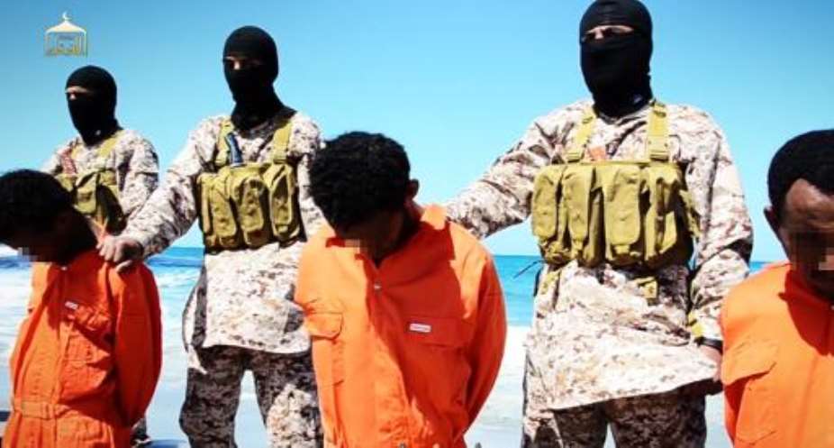Men described as Ethiopian Christians captured in Libya kneeling on the ground in front of masked militants before their beheading on a beach at an undisclosed location in Libya.  By  Al-Furqan MediaAFP