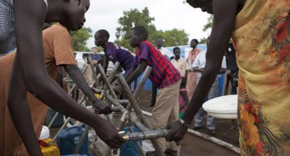 South Sudanese refugees fetch water at a watering point in a camp for Internally Displaced People in Gambella, Ethiopia, on July 10, 2014.  By Zacharias Abubeker AFPFile