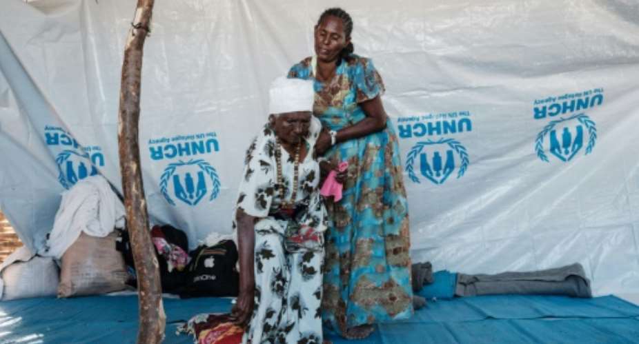 Ethiopian Asafu Alamaya L, an 80-year-old blind woman who fled the Tigray conflict, is helped by her daughter at the Um Raquba refugee camp in Sudan's eastern Gedaref state, on December 12, 2020: the UN expressed frustration at lack of access to Tigray.  By YASUYOSHI CHIBA AFP