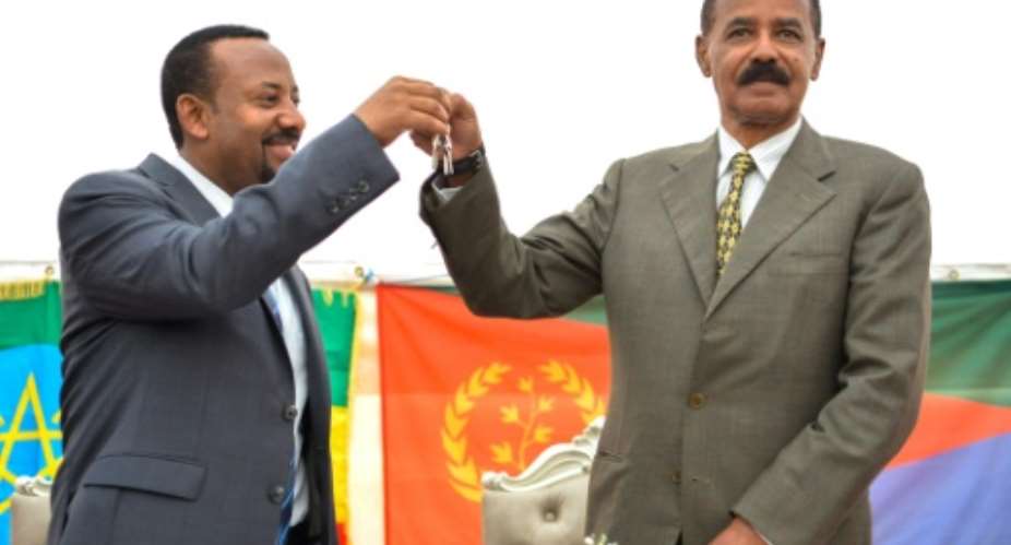 Ethiopian Prime Minister Abiy Ahmed left and Eritrean President Isaias Afwerki celebrate the reopening of the Embassy of Eritrea in Ethiopia in Addis Ababa on July 16, 2018.  By MICHAEL TEWELDE AFPFile