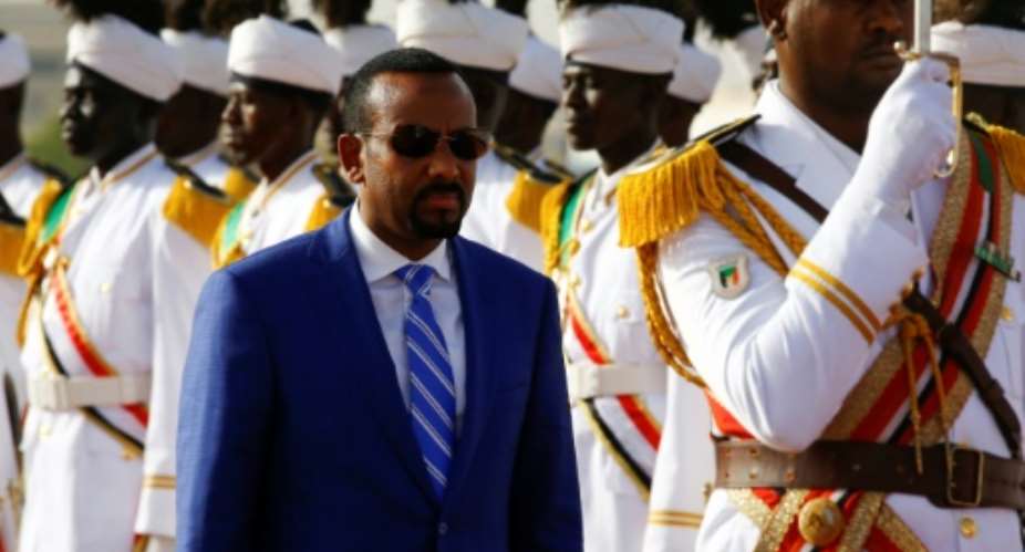 Ethiopian Prime Minister Abiy Ahmed reviews the honour guard following his arrival in Khartoum for an official visit to Sudan on May 2, 2018.  By ASHRAF SHAZLY AFP