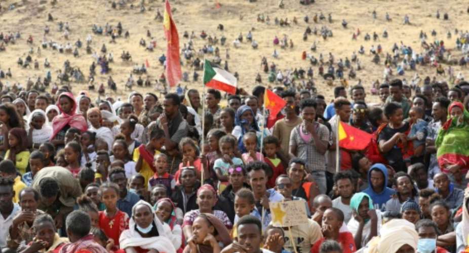 Ethiopian refugees gather to celebrate the 46th anniversary of the Tigray People's Liberation Front at Um Raquba refugee camp in Gedaref, eastern Sudan, on February 19, 2021.  By Hussein Ery AFP