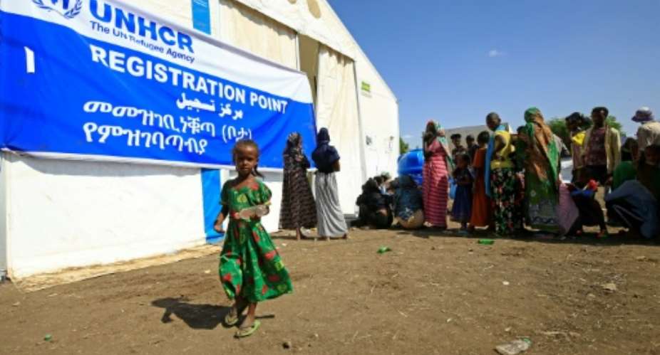 Ethiopian refugees, who have fled the Tigray conflict, queue for food outside UNHCR and World Food Programme tents at a transit centre in Sudan's border town of Hamdayit.  By ASHRAF SHAZLY AFP