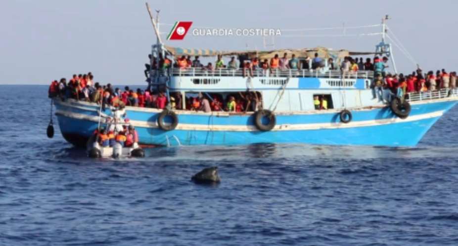 An Italian Coast Guards Guardia Costiera video grab released on August 23, 2015 shows migrants on an overcrowded boat off the coast of Libya.  By  Guardia CostieraAFP