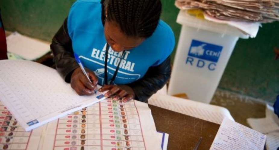 An election official at the Twalemishe school polling station begins counting votes in November 2011.  By Phil Moore AFPFile