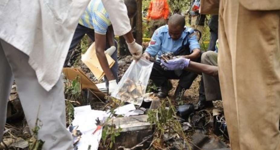 Forensic experts gather evidence at the crash site.  By Simon Maina (AFP/File)