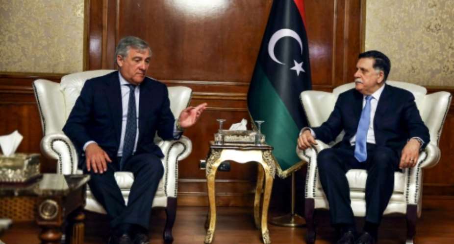 European Parliament President Antonio Tajani L meets with Libya's unity government Prime Minister Fayez al-Sarraj at his office in the capital Tripoli on July 9, 2018.  By STRINGER AFP