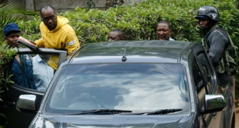 Evan Mawarire, seen here being taken away by police, has been accused of inciting violence through social media.  By Jekesai NJIKIZANA AFP