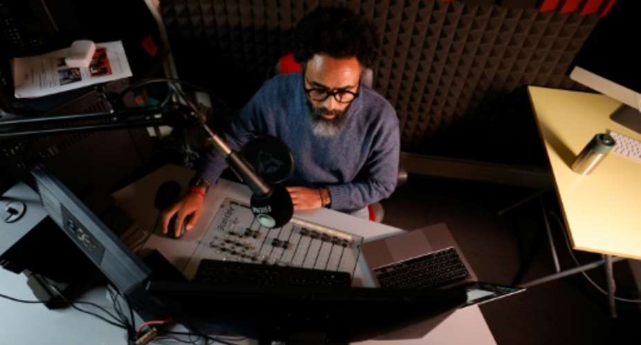 Exiled Eritrean journalist Amanuel Ghirmaile records a program in the studio of Radio Erena in Paris.  By Gregoire CAMPIONE (AFP)