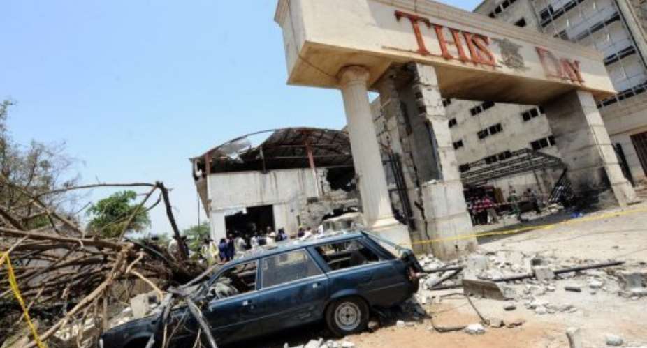 A destroyed car sits outside the premises of ThisDay Newspapers bombed in Abuja in April 2012.  By Pius Utomi Ekpei AFPFile