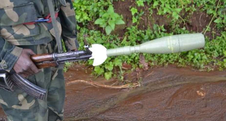 A Democratic Republic of Congo soldier holds a self-propelled rocket in the eastern North Kivu region on November 5, 2013.  By Habibou Bangre AFPFile