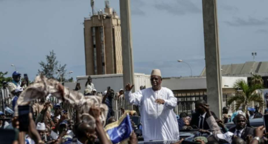Ex-Senegalese president Macky Sall acknowledges the crowd outside Leopold Sedar Senghor Military Airport, after landing in Dakar on July 17, 2026.  By Patrick MEINHARDT (AFP)