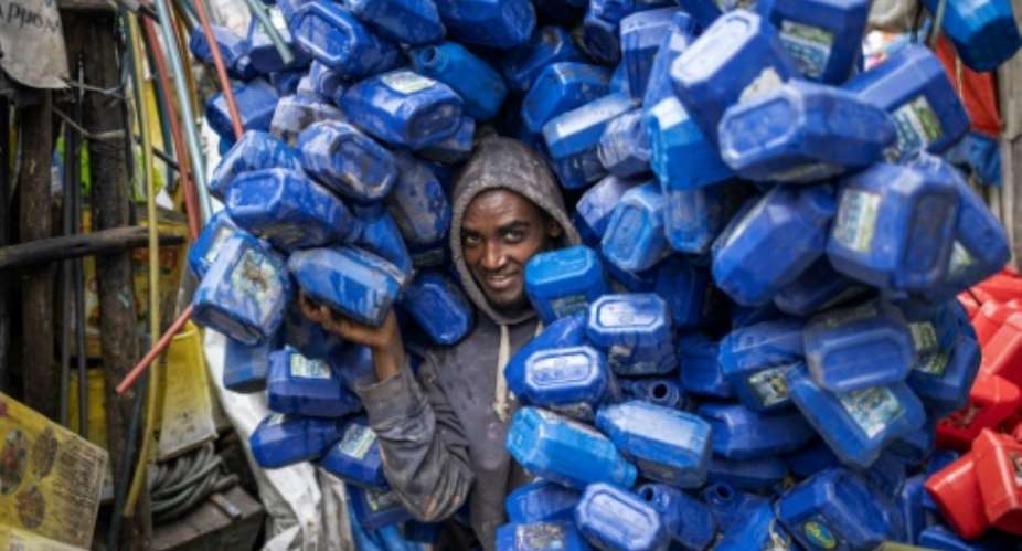 Ezedin Muste, 23, is one of thousands of waste collectors known in Amharic as korale.  By Michele Spatari (AFP)