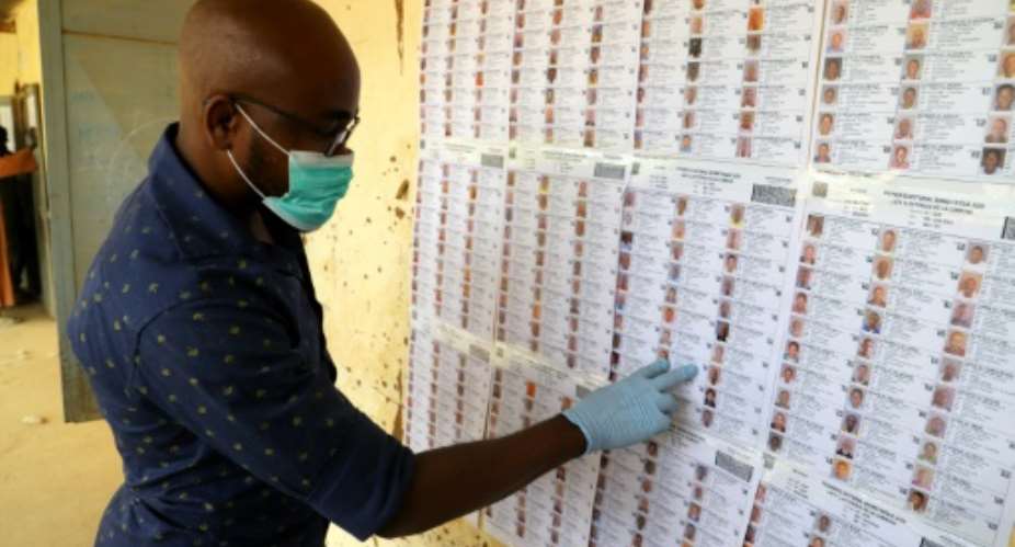 Face masks and gloves are new to election workers preparing polling stations for Mali's vote.  By Souleymane Ag Anara AFP