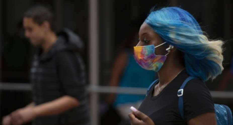 Face masks are reappearing in cities around the world as the Delta variant fuels a surge in coronavirus cases.  By Kena Betancur AFP