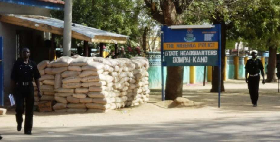 Policemen walk outside police headquarters in Kano on January 24, 2012.  By Aminu Abubakar AFPFile