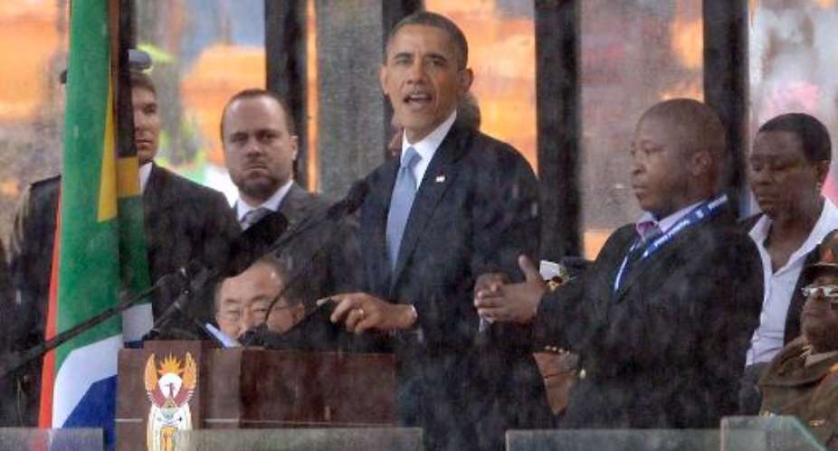 Barack Obama delivers a speech during the memorial service for Nelson Mandela at Soccer City Stadium in Johannesburg on December 10, 2013.  By Pedro Ugarte AFP