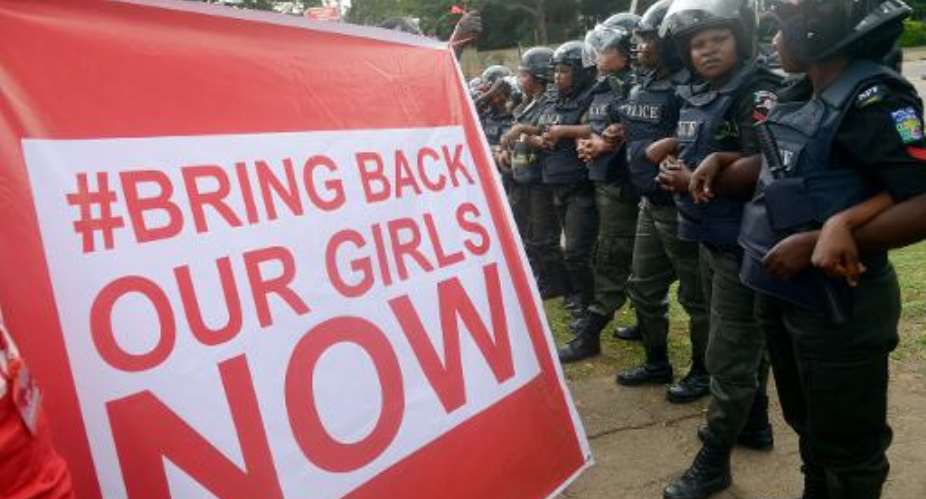 Supporters of the BringBackOurGirls campaign demonstrate in Abuja on October 14, 2014.  By Pius Utomi Ekpei AFP