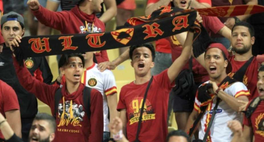 Fans of Tunisian football club Esperance Sportive de Tunis cheer as their side holds Egypt's Al-Ahly FC to a 0-0 draw in their CAF Champions League group A match.  By STRINGER AFPFile