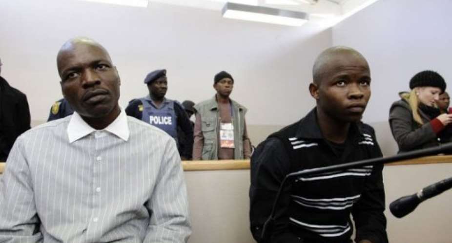 Defendants Chris Mahlungu L and Patrick Ndlovu sit in the dock.  By Stephane de Sakutin AFP