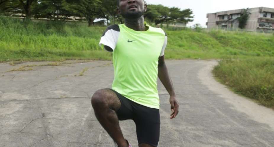 Fast but poor: Gabonese paralympic athlete Davy Moukagni trains for the 100m.  By Steeve JORDAN AFP