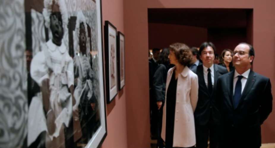 French President Francois Hollande R and French Culture Minister Audrey Azoulay C visit the exhibition of Malian photographer Seydou Keita at the Grand Palais in Paris.  By Yoan Valat PoolAFP