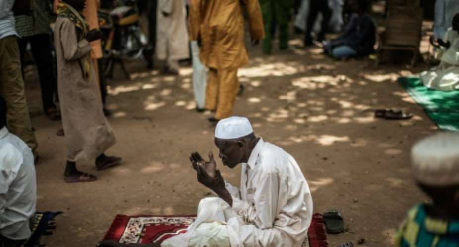 A Muslim prays at the Grand Mosque in the PK5 neighborhood of Bangui, two days ahead of a historic visit by Pope Francis.  By Gianluigi Guercia AFP