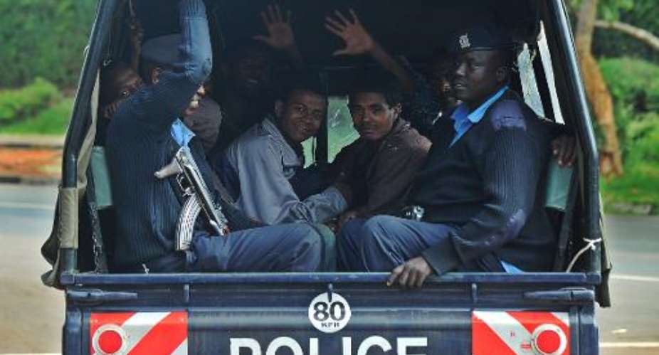 Somali and Ethiopian nationals arrested as part of a crackdown on terrorism by Kenyan national security officers sit in a police truck on April 17, 2014, in Nairobi.  By Tony Karumba AFPFile
