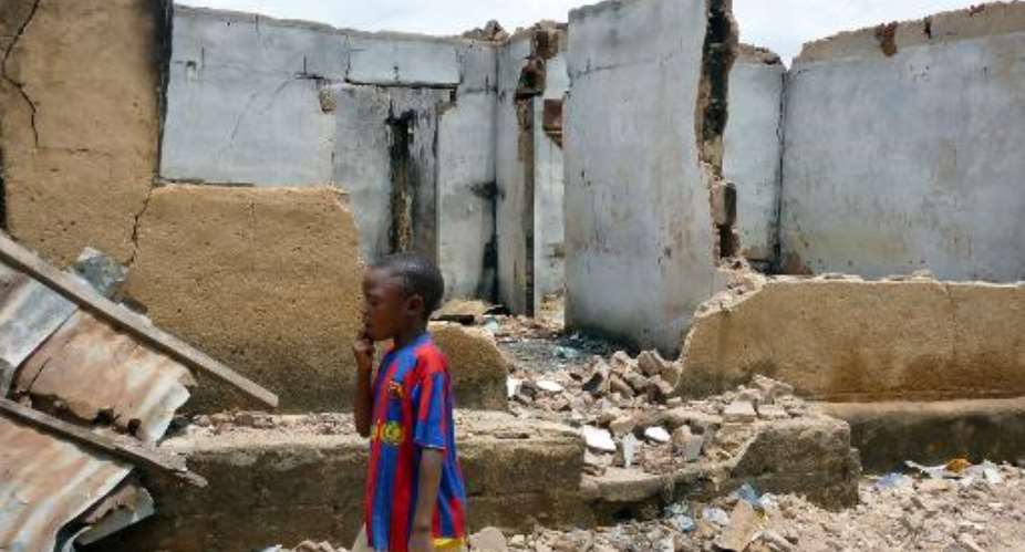 A boy walks past one of the houses destroyed during the January sectarian violence in Jos, in Plateau State on April 29, 2010.  By Susan Njanji AFPFile