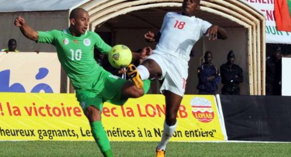 Sofiane Feghouli left challenges Burkina Faso's Charles Kabore during a World Cup qualifier on October 12, 2013 in Ouagadougou.  By Farouk Batiche AFP