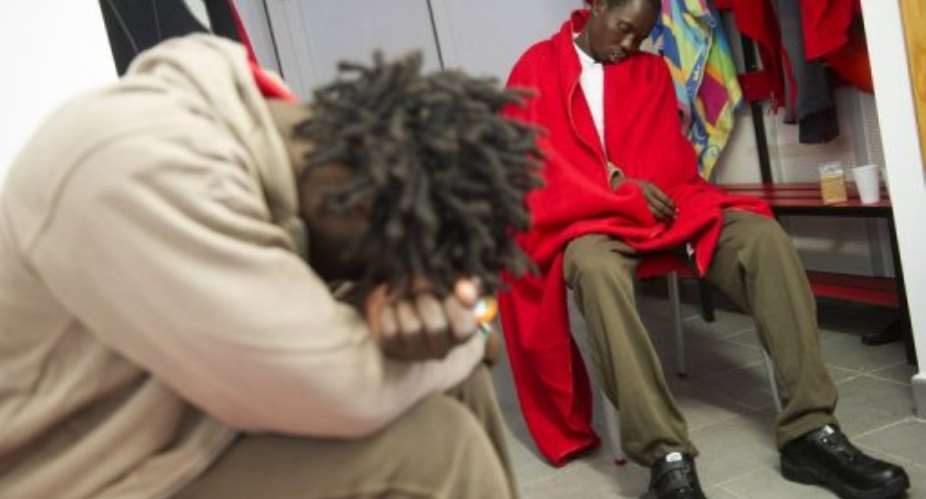 Would-be immigrants rest at the Red Cross premises at Tarifa's harbour in Spain on August 12, 2013.  By Marcos Moreno AFP
