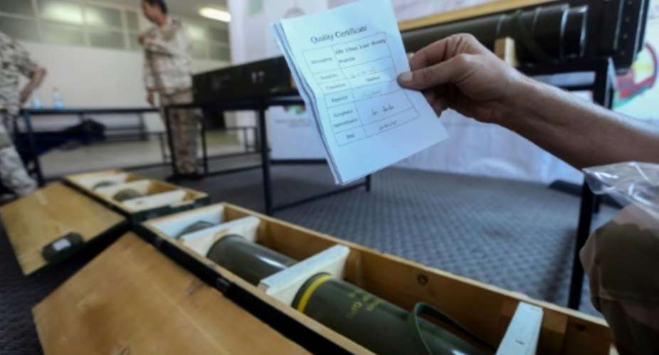 Fighters loyal to Libya's UN-recognised government display Chinese-made shells bearing the markings of the United Arab Emirates, reportedly seized from Haftar's forces, in June 2019.  By - AFP