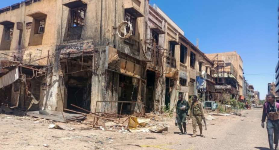Fighters loyal to the army patrol a market area in Khartoum.  By - (AFP)