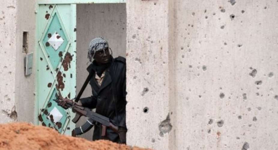 New regime forces are still facing pockets of resistance.  By Aris Messinis (AFP)