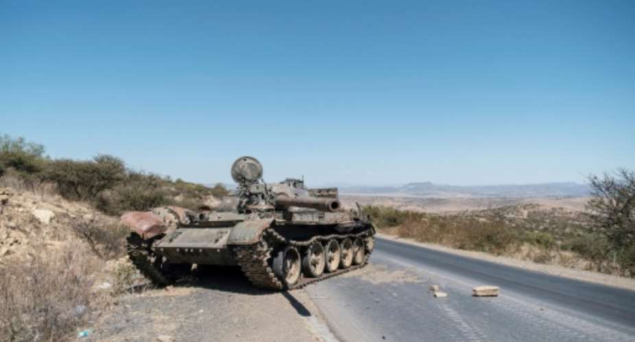 Fighting: A damaged tank pictured on a road north of Mekele, the capital of Tigray, in February.  By EDUARDO SOTERAS AFPFile
