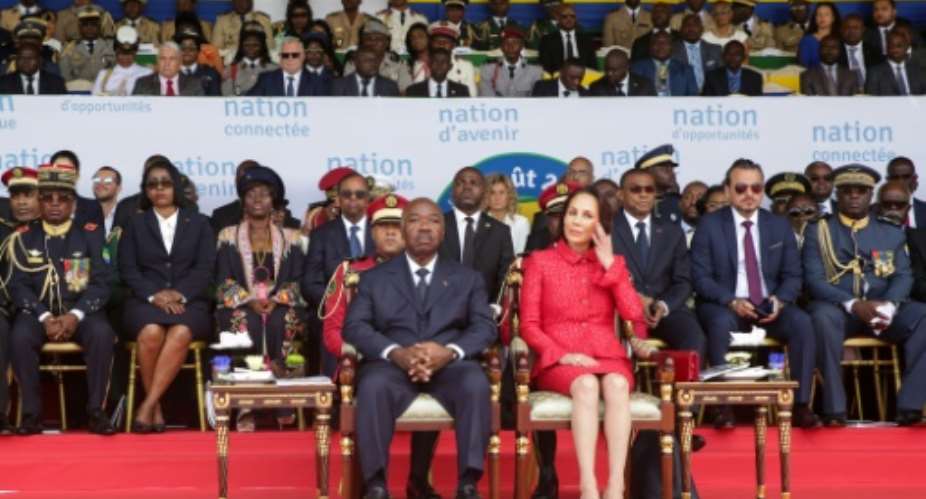 File picture from Gabon's independence day celebrations on August 17, with President Ali Bongo and his wife Sylvia sitting on the tribune and Bongo's chief of staff, Brice Laccruche Alihanga, seated behind them, second from right.  By Steve JORDAN AFPFile