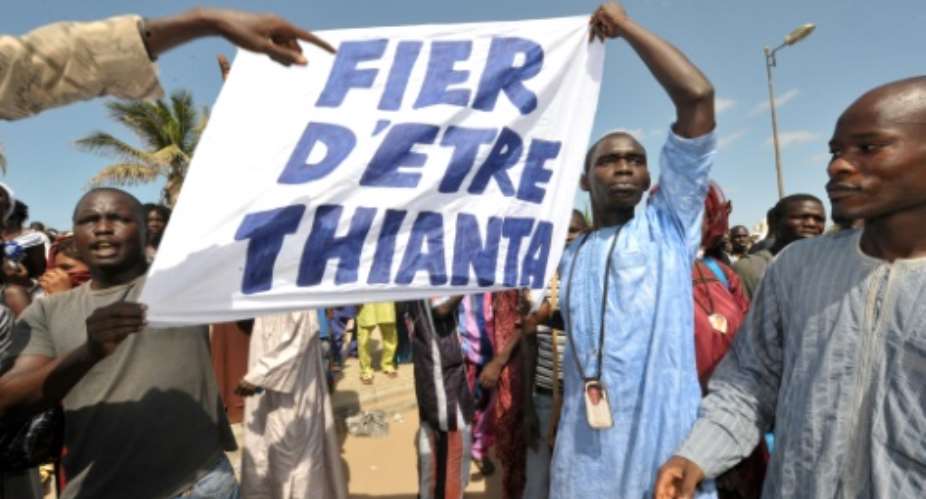 File picture of Thioune's supporters, called 'Thiantacounes,' protesting outside a Dakar prison in October 2012 to demand his release. The placard reads Proud to be Thianta.  By SEYLLOU AFP