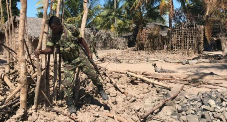 File picture shows Mozambique soldier looking at a burned village structure in the north of the country where over the past year, hardline Islamists have been active.  By Joaquim Nhamirre AFPFile