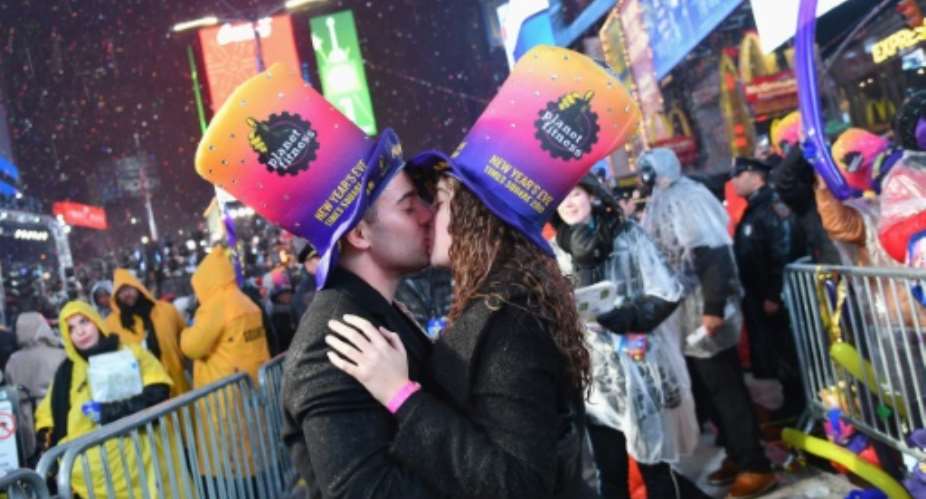 Fireworks exploded overhead and couples kissed as revelers welcomed the New Year in New York City's Times Square.  By Angela Weiss AFP