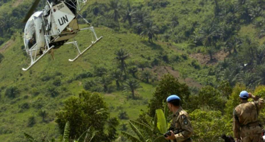 UN peacekeeping forces watch a UN helicopter take off from an airstrip at Bunyakiri base in South Kivu province, DR Congo on February 25, 2006.  By Jose Cendon AFPFile