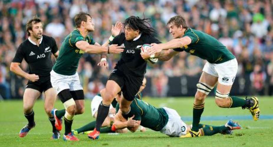 Ma'a Nonu from New Zealand C is tackled by JJ Engelbrecht 2ndL and Eben Etzebeth from South Africa R during their 2013 Rugby Union Four Nations match on October 5, 2013 at the Ellis Park Stadium in Johannesburg.  By  AFP