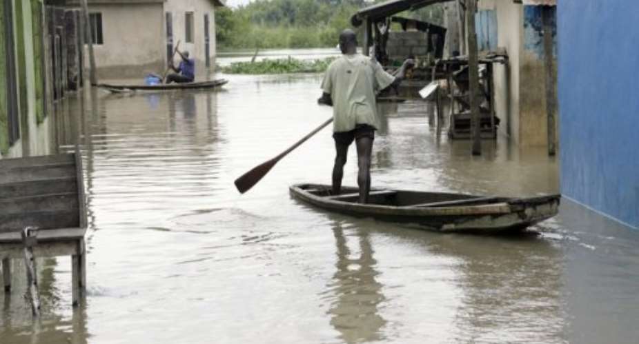 Men paddle canoes to their homes in Lagos during previous flooding in 2010.  By Pius Utomi Ekpei (AFP/File)
