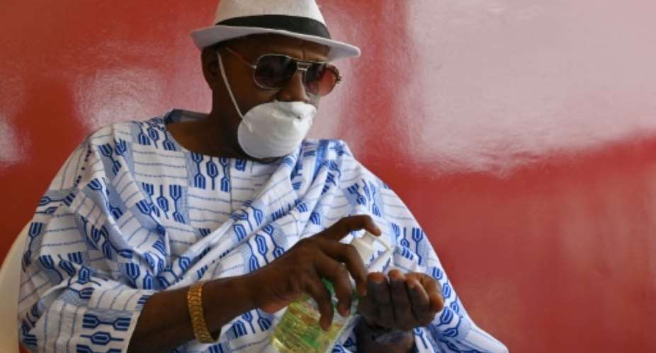 Follow my lead: King Nanan Ako Ako Omer at a meeting with advisers on the coronavirus pandemic.  By ISSOUF SANOGO AFP