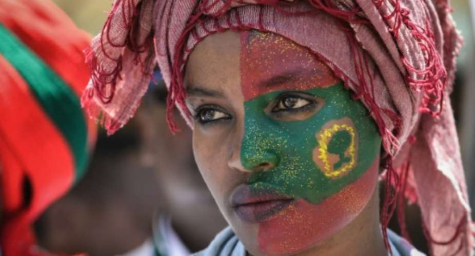 Follower: A woman's face is painted with the flag of the Oromo Liberation Front at celebrations in September 2018 to mark the return of the once-banned OLF to Addis Ababa.  By MIchael TEWELDE AFP