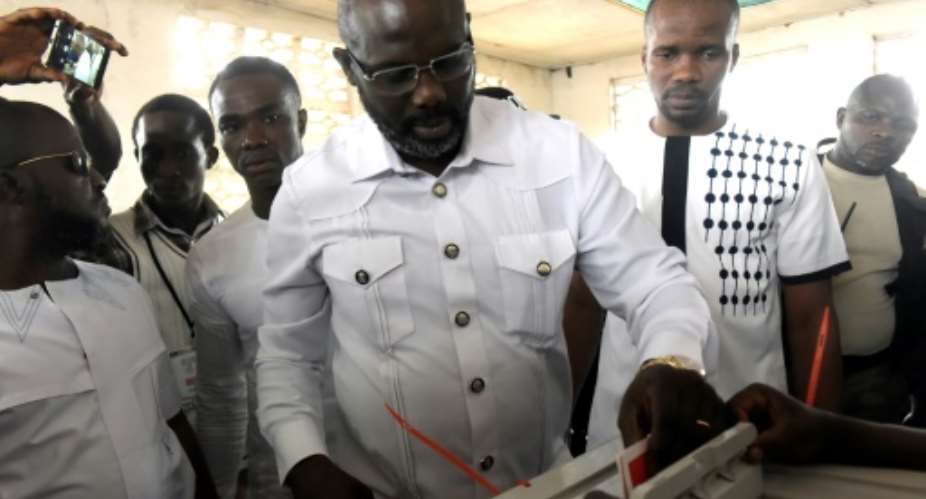 Football icon George Weah has won an insurmountable 61.5 percent in the Liberian presidential run-off.  By SEYLLOU AFP