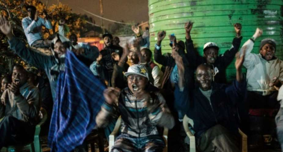Footy mania: Kenyan fans rejoice as Nigeria scores a penalty against Argentina in a group match.  By Yasuyoshi CHIBA AFP