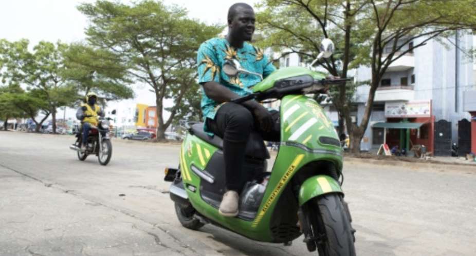 For many drivers in Cotonou, electric motorcycles are more a question of cost than pollution.  By Yanick Folly (AFP)