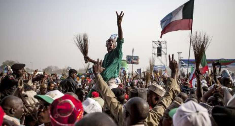 Supporters of the main Nigerian opposition All Progressives Congress APC party cheer as they attend a rally in the northern city of Kaduna on January 19, 2015.  By Florian Plaucheur AFPFile