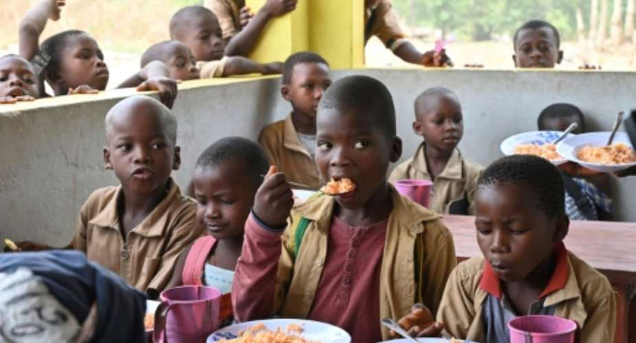For these Ivorian children, the canteen is a big draw of primary schooling made possible by village women.  By ISSOUF SANOGO AFPFile